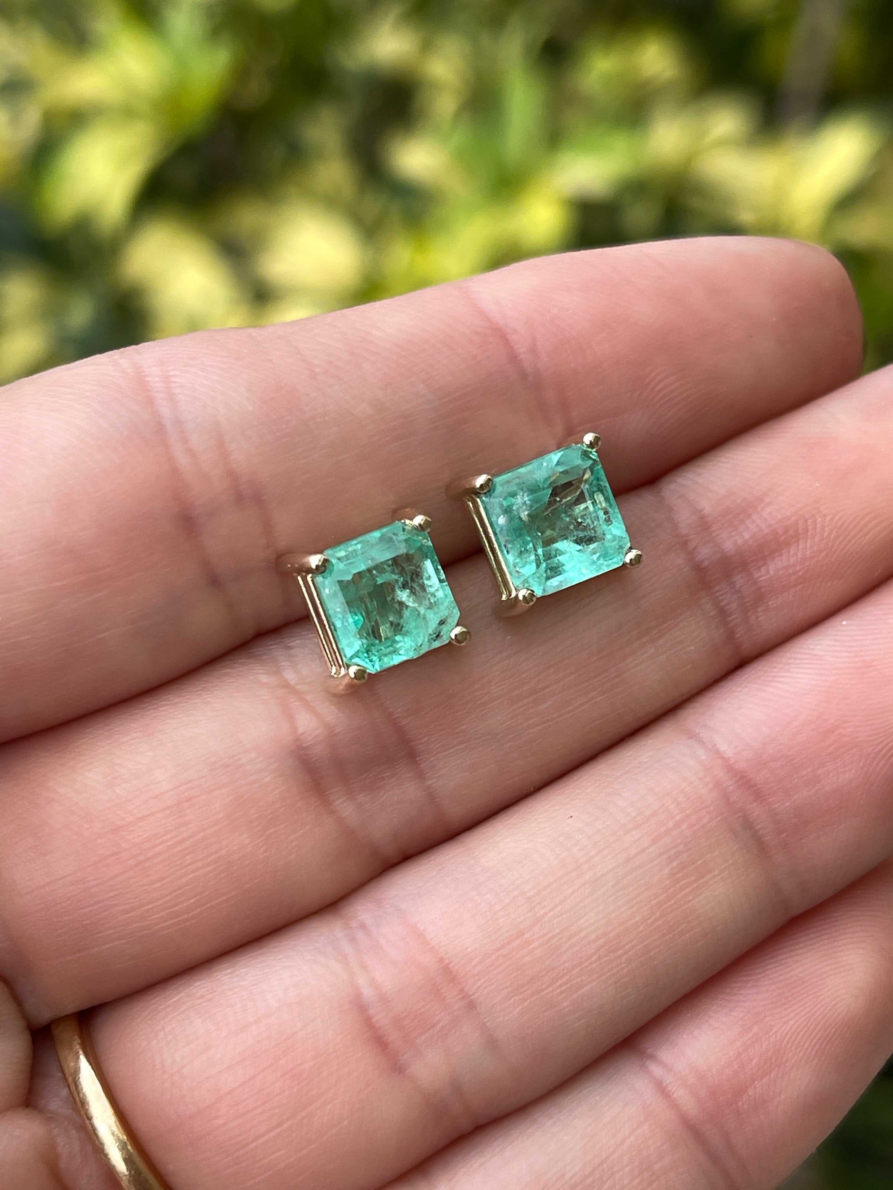 Pair of Colombian emerald stud earrings with 3.97 carats of earthy-spring green Asscher cut gemstones in 14K setting