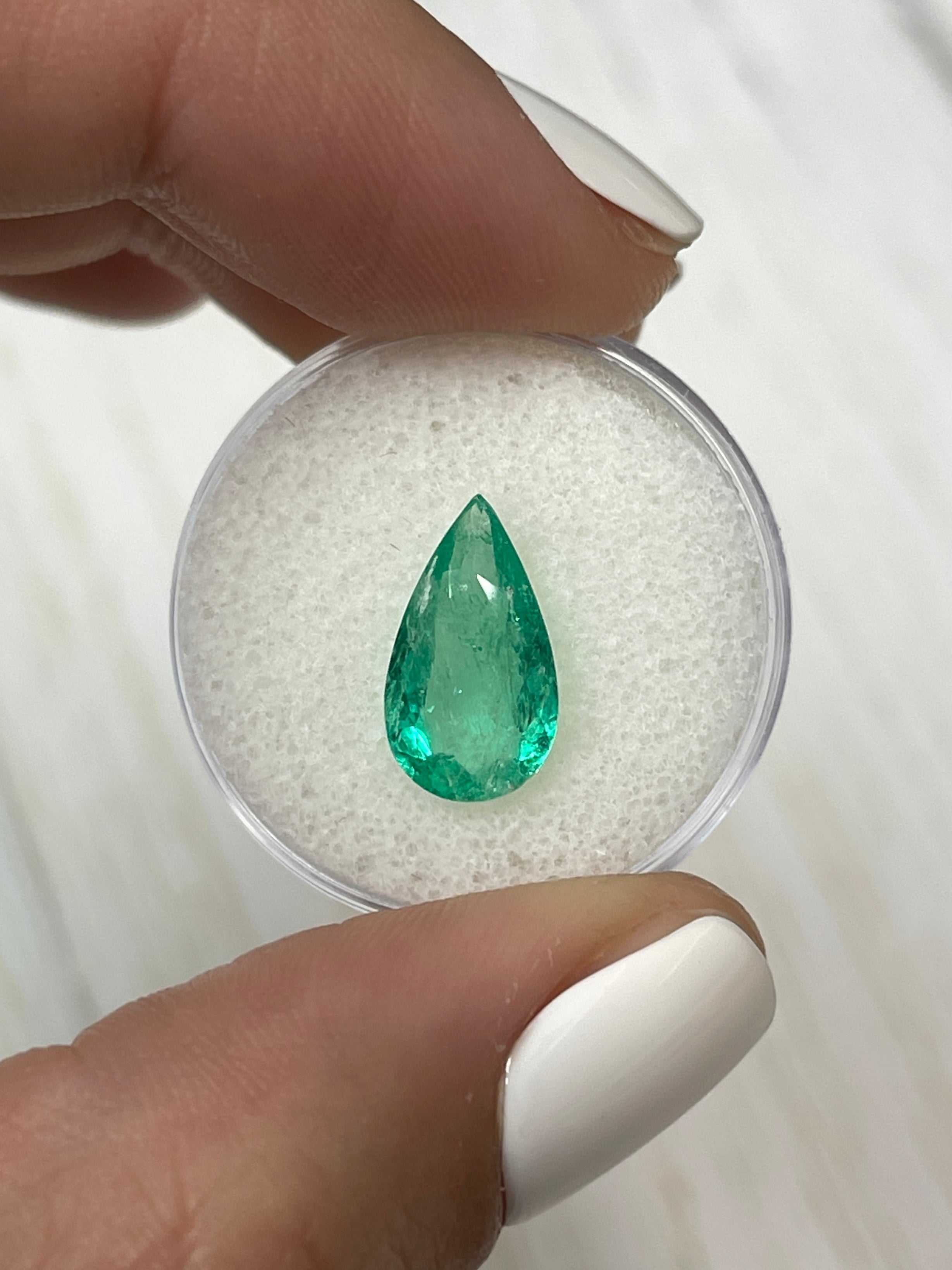 Natural 2.61 carat Colombian emerald loose gemstone in pear cut, 14x8mm, featuring vibrant green color and spready shape by JR Colombian Emeralds.