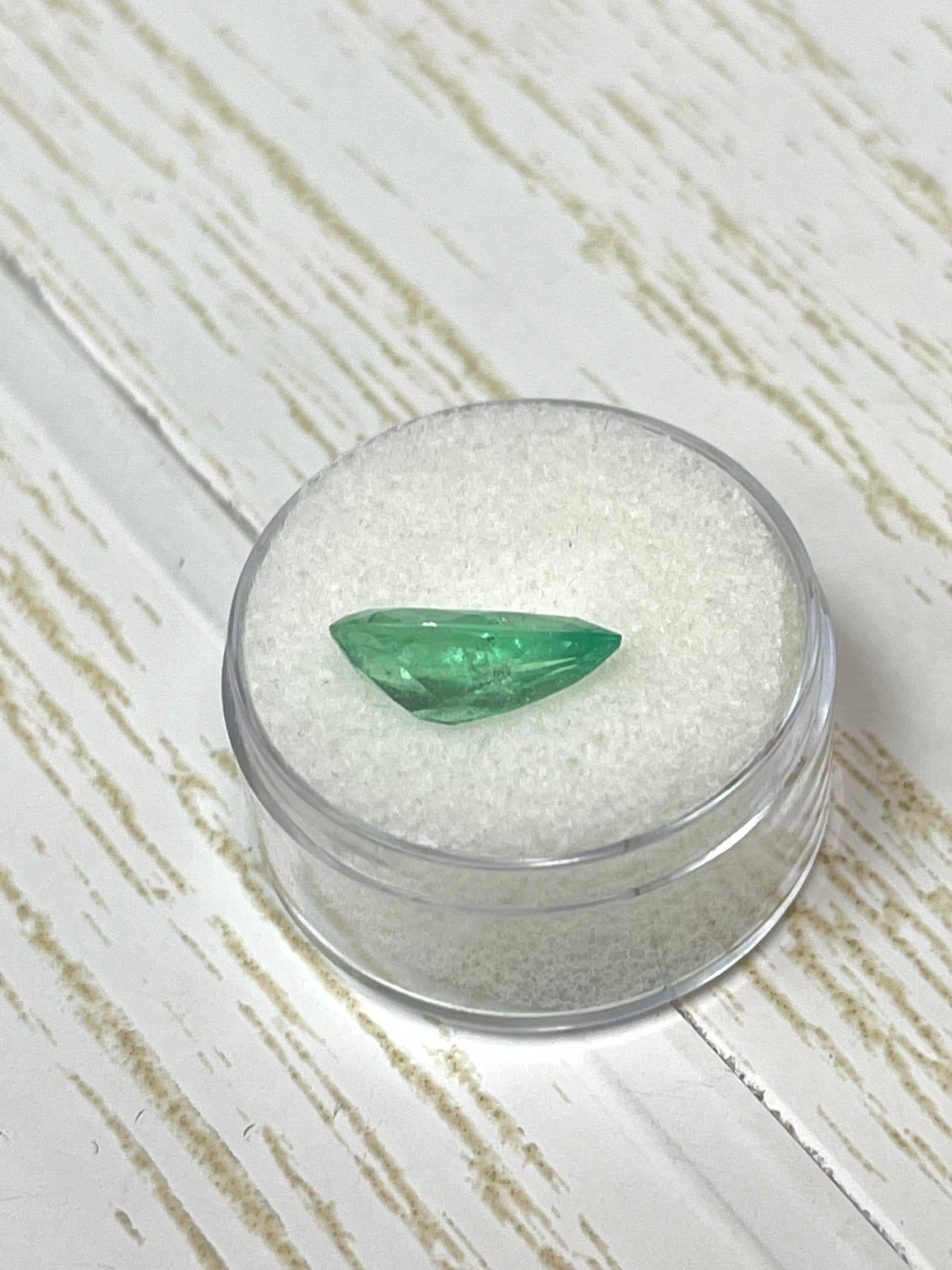 Elongated pear cut Colombian emerald weighing 2.76 carats, showcasing vibrant green color and natural inclusions.
