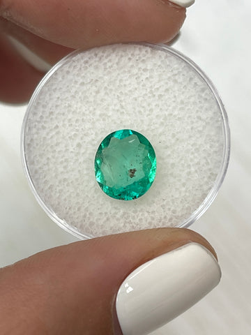 Oval Cut Colombian Emerald: 1.80 Carat Loose Gemstone with Unique Green Freckles