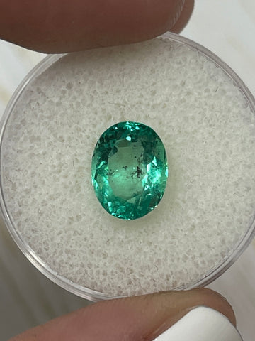 Captivating 2.83 Carat Oval Cut Colombian Emerald with Vibrant Green Hue and Freckled Inclusions
