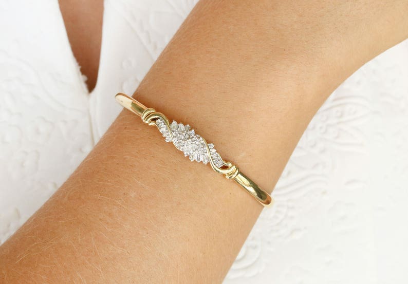 14K gold bangle bracelet featuring vintage 0.88tcw natural white diamond baguette accents by Colombian Emerald