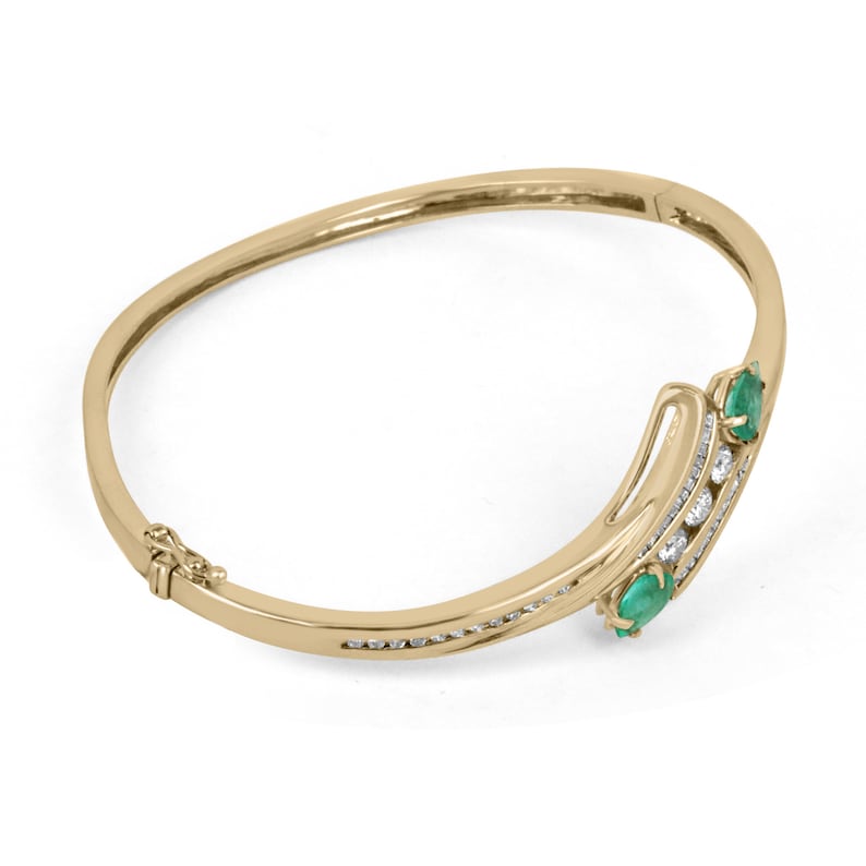Colombian Emerald yellowish green round cut bangle bracelet with 1.95tcw and triple diamond accents in 14K yellow gold.