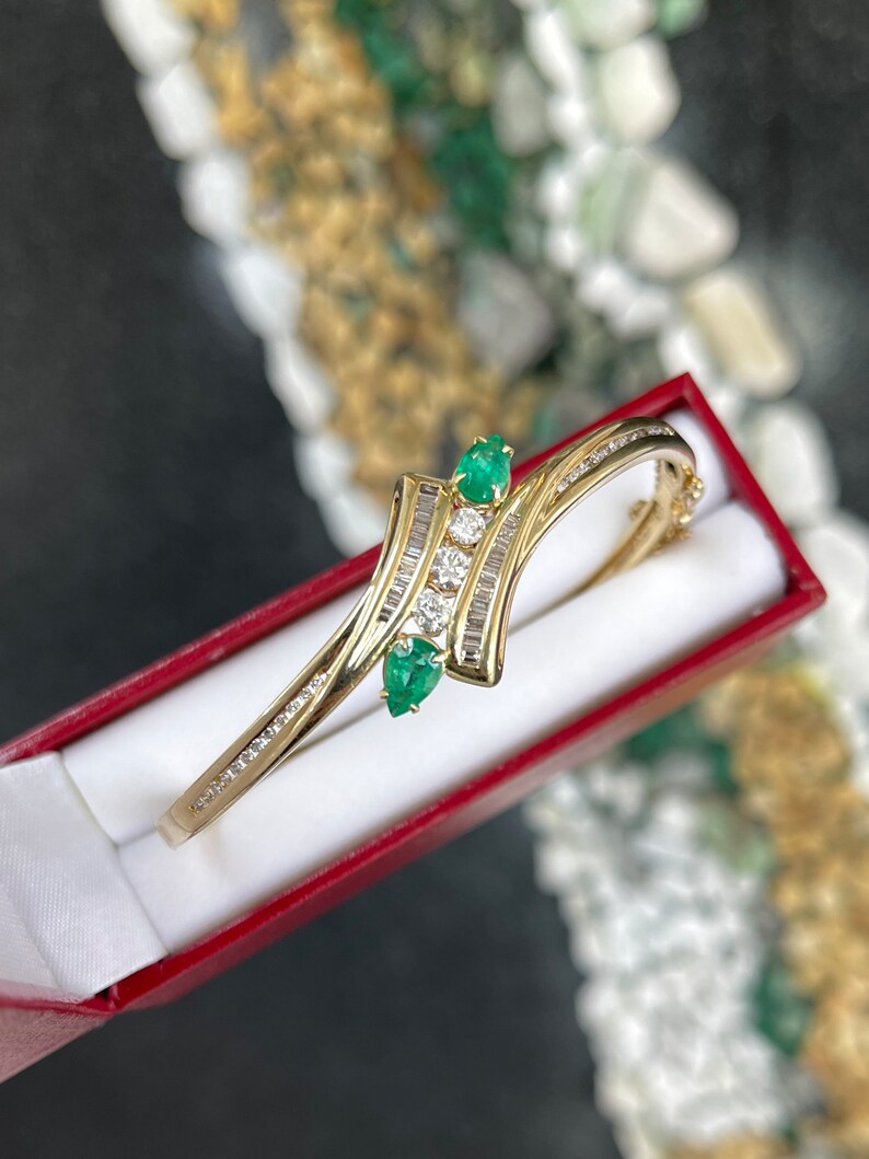 14K yellowish green emerald bangle bracelet with round cut emeralds and triple diamond accents, Colombian Emerald jewelry.