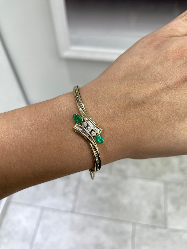 14K yellowish green emerald bangle bracelet with round cut emeralds and triple diamond accents from Colombian Emerald.