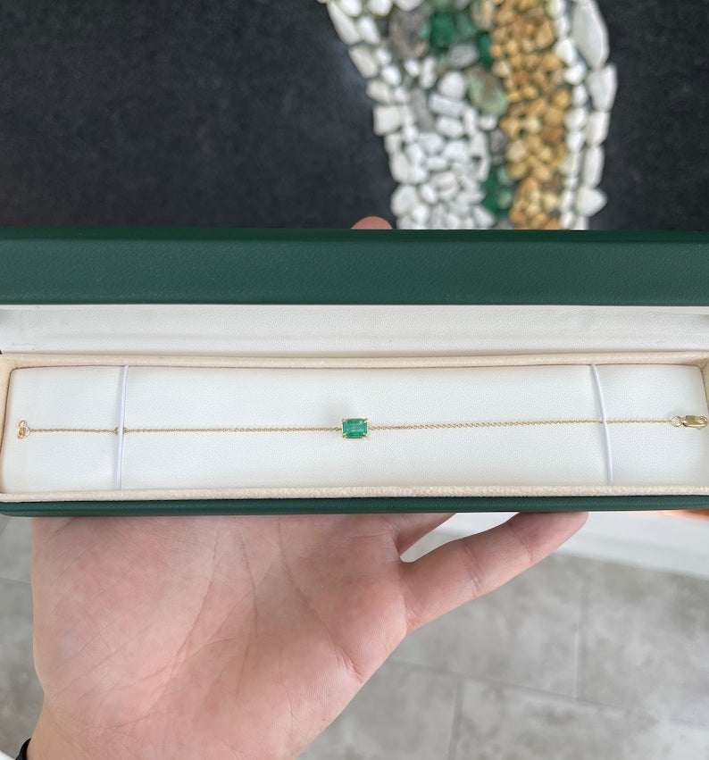 Natural 1.0 carat rich green Colombian emerald claw prong solitaire bracelet in 14K gold.