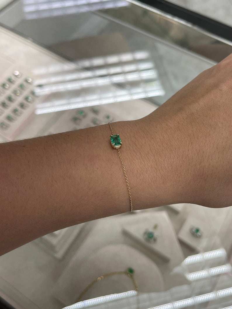 Natural emerald bracelet featuring a 1.0 carat rich green Colombian emerald in a claw prong solitaire setting on 14K gold.