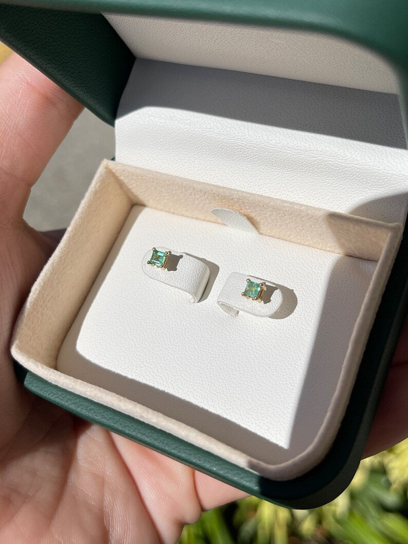 Pair of 0.45tcw natural Colombian emerald petite baby princess Asscher cut stud earrings in 14K gold.