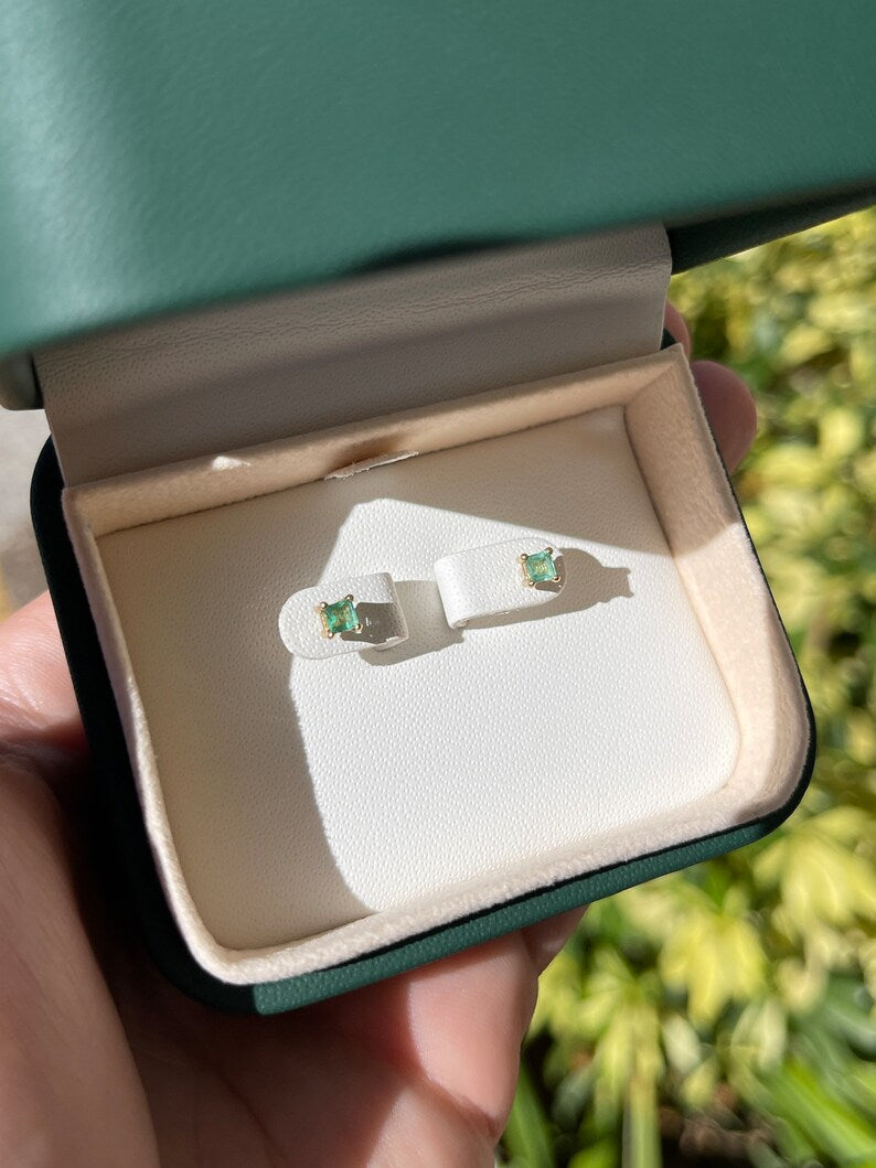 Colombian Emerald 0.45tcw petite baby princess Asscher cut stud earrings in 14K gold, featuring vibrant green emeralds.