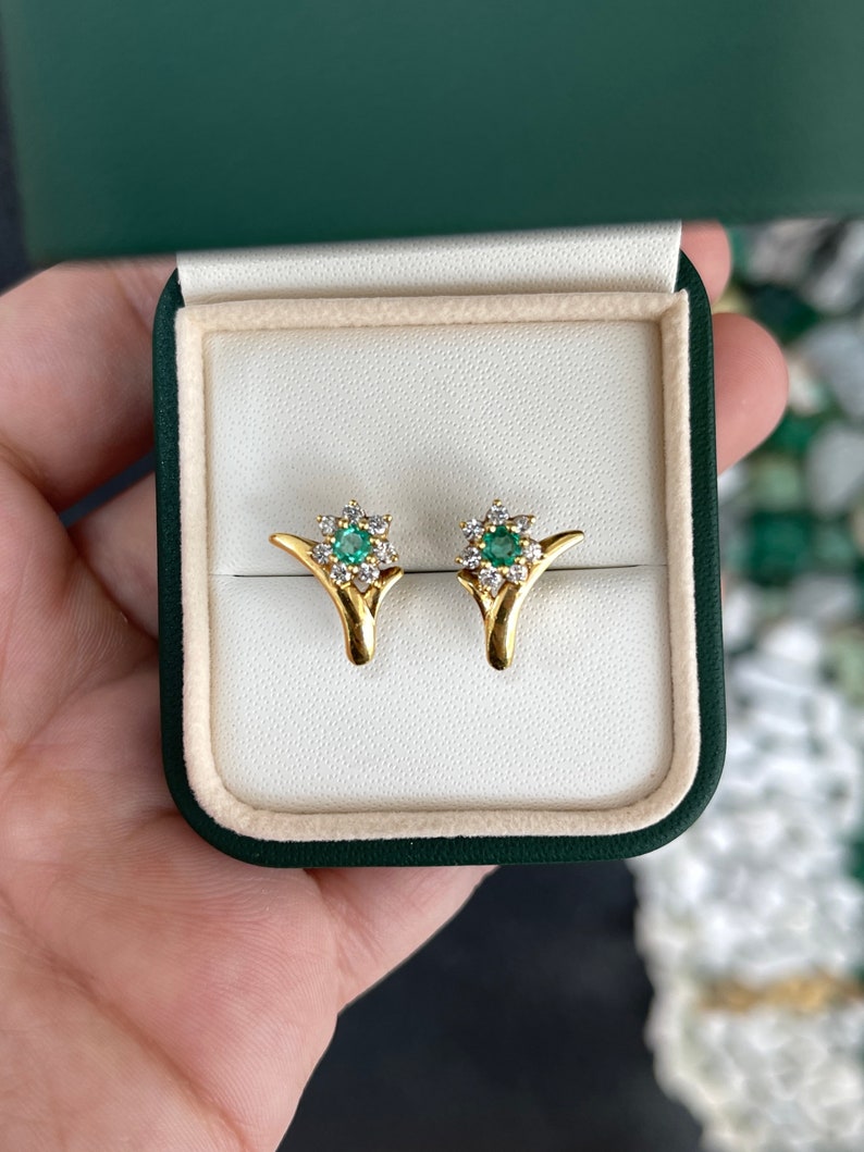 Colombian Emerald 0.71tcw natural spring green emerald and diamond floral halo accent earrings in 18K gold.