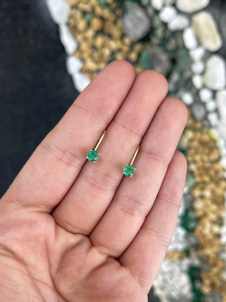 14K yellow gold Colombian Emerald earrings with round emeralds and leverback clasps, totaling 0.80 carats.