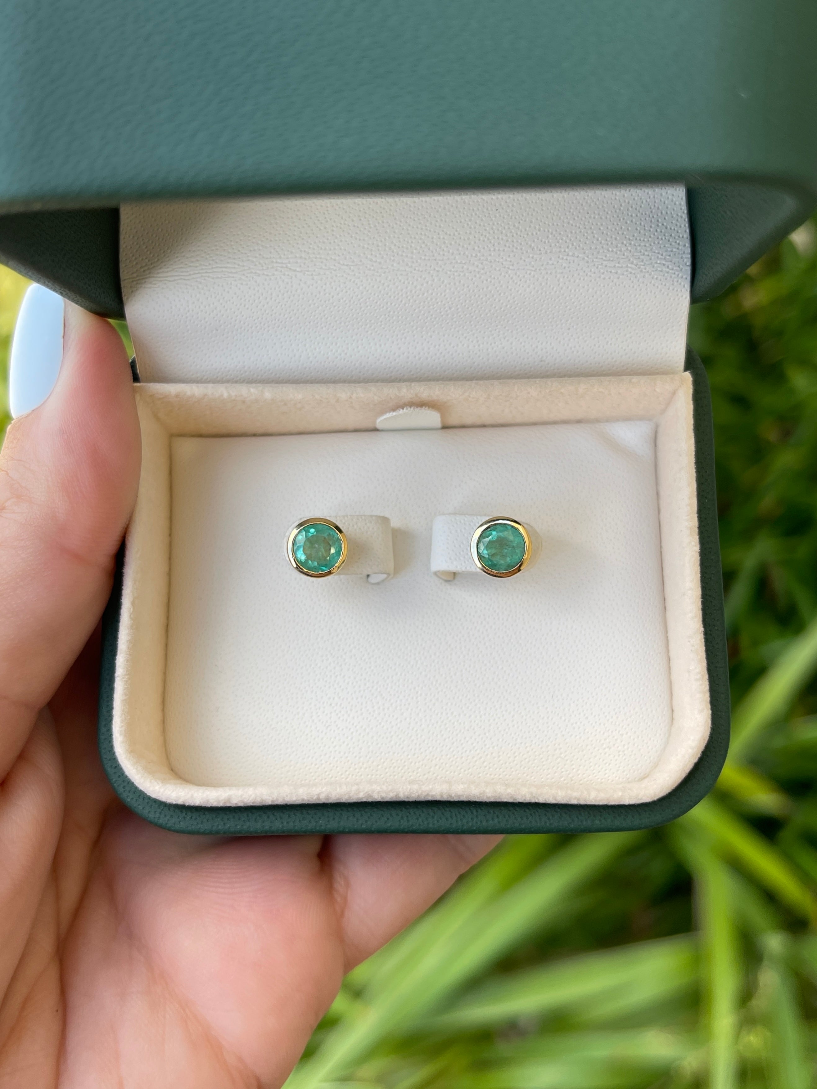 14K gold Colombian Emerald earrings with round-cut natural emeralds and push-back closure, totaling 1.60tcw.