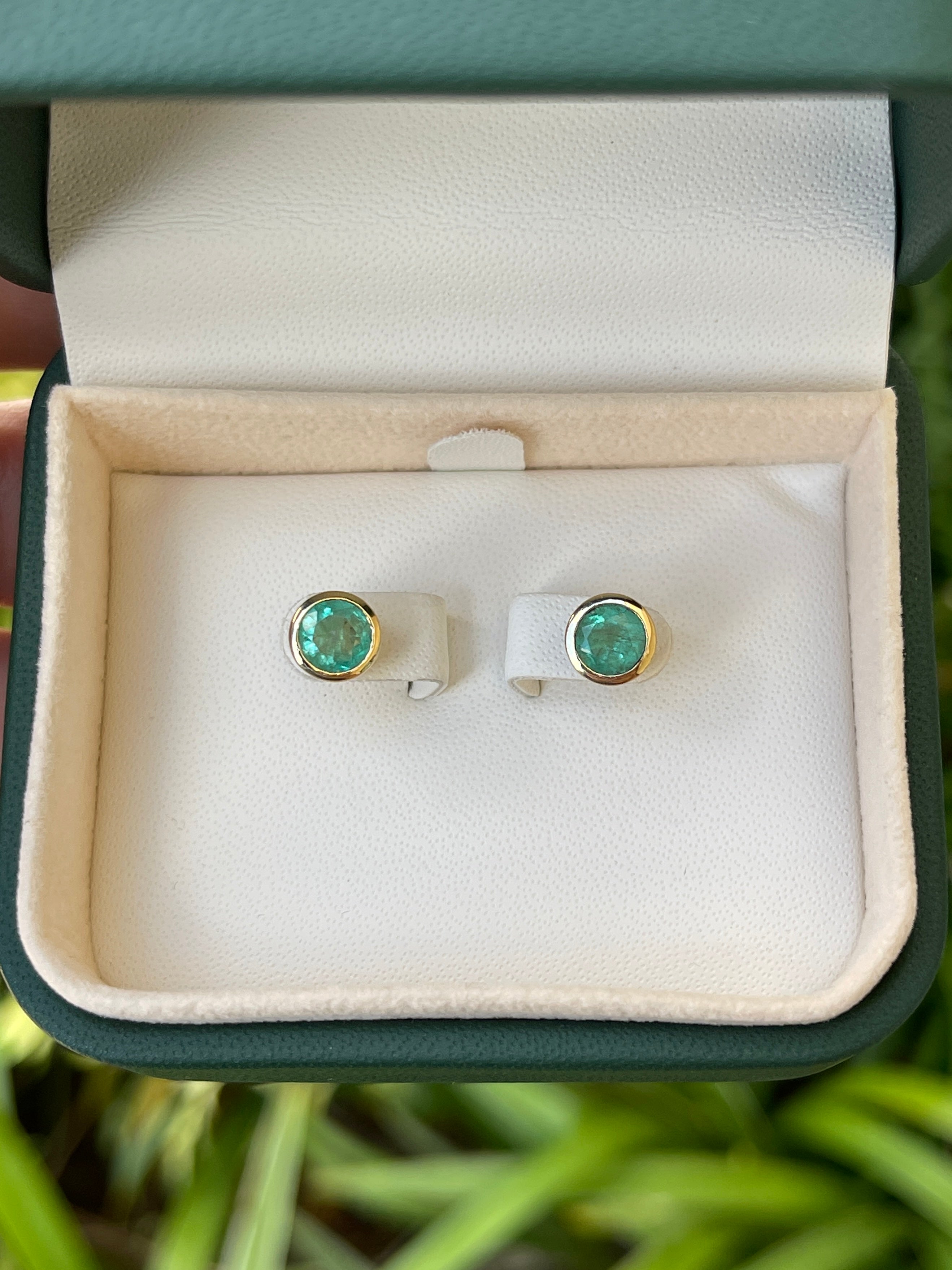 Round cut natural emerald earrings with 1.60 tcw, 14K gold, Colombian Emerald brand, featuring push back clasps.