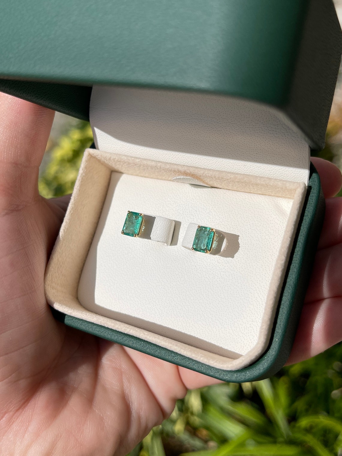 14K Colombian Emerald May birthstone stud earrings with 1.81tcw natural emerald cut gemstones.