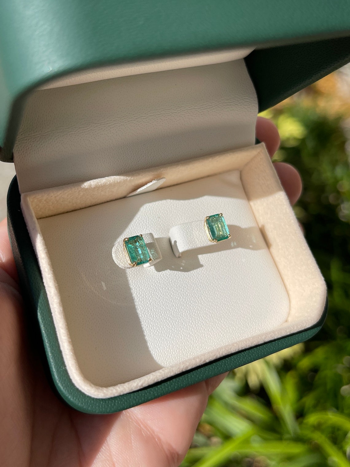 Colombian Emerald 1.81ctw 14K natural emerald cut May birthstone stud earrings, featuring vibrant green gemstones.