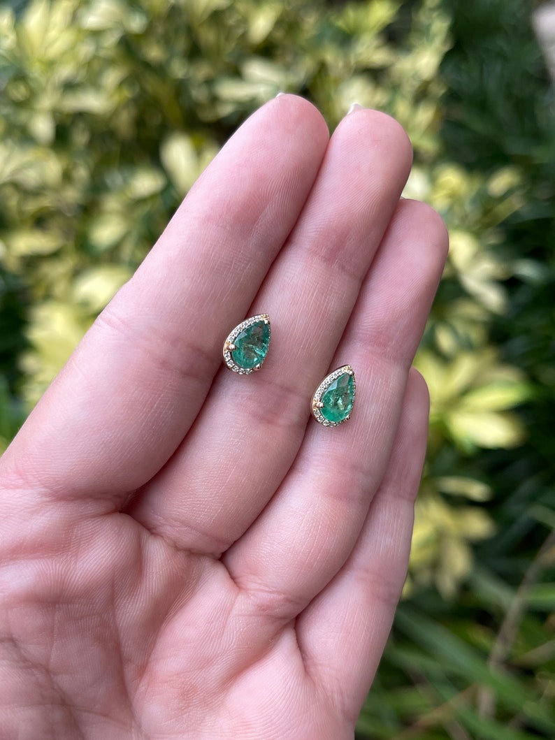 14K yellow gold teardrop earrings with emerald and diamond pave halo, featuring pear-shaped gemstones and intricate detailing.