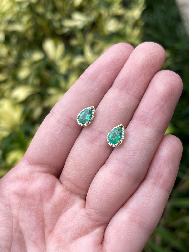 14K yellow gold teardrop pear earrings with emerald and diamond pave halo, featuring 1.87tcw Colombian emerald gemstones.