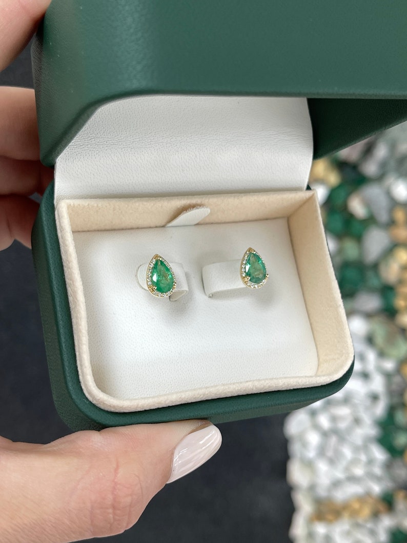 14K yellow gold teardrop earrings with emerald and diamond pavé halo, featuring pear-shaped emeralds and sparkling accents.