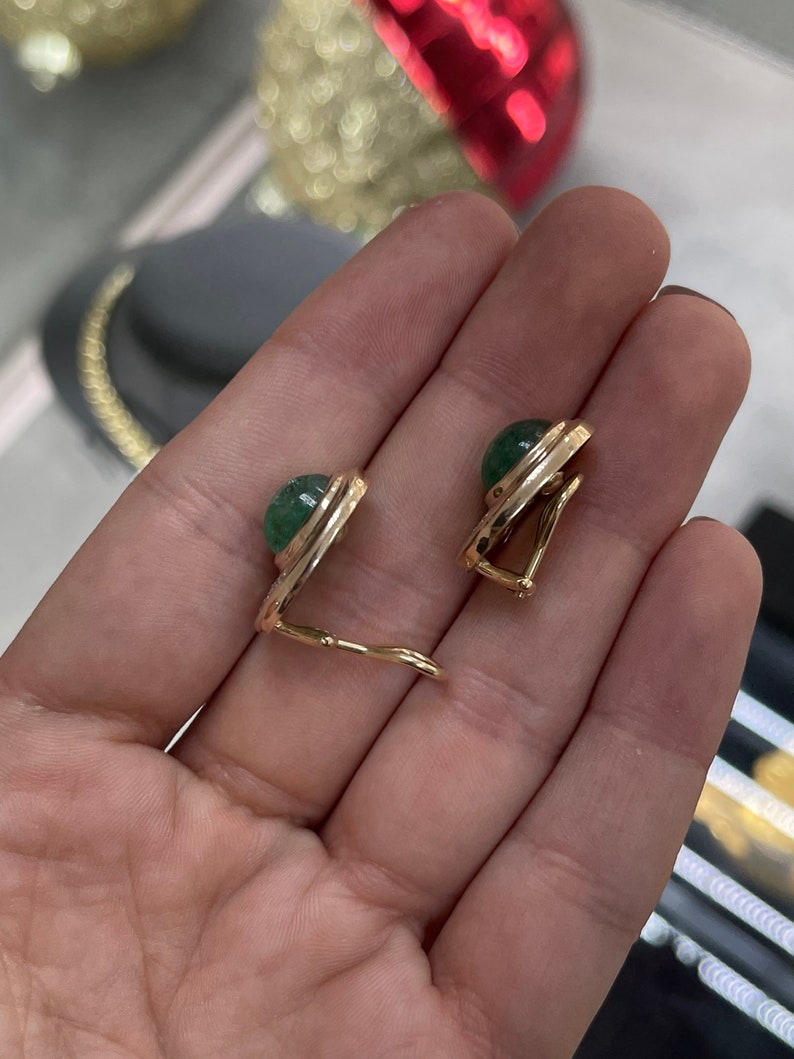 14K yellow gold emerald cabochon and diamond accent clip-on earrings with Colombian emeralds and elegant design.