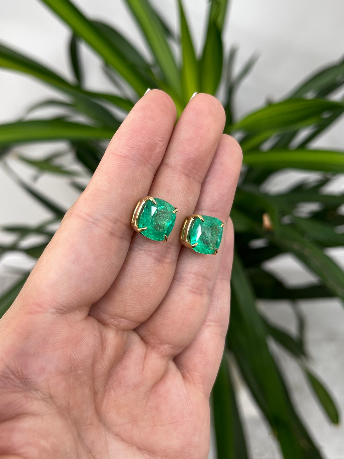 Colombian Emerald earrings with 11.80tcw AAA cushion cut emeralds in 18K gold, featuring four-claw prong settings.