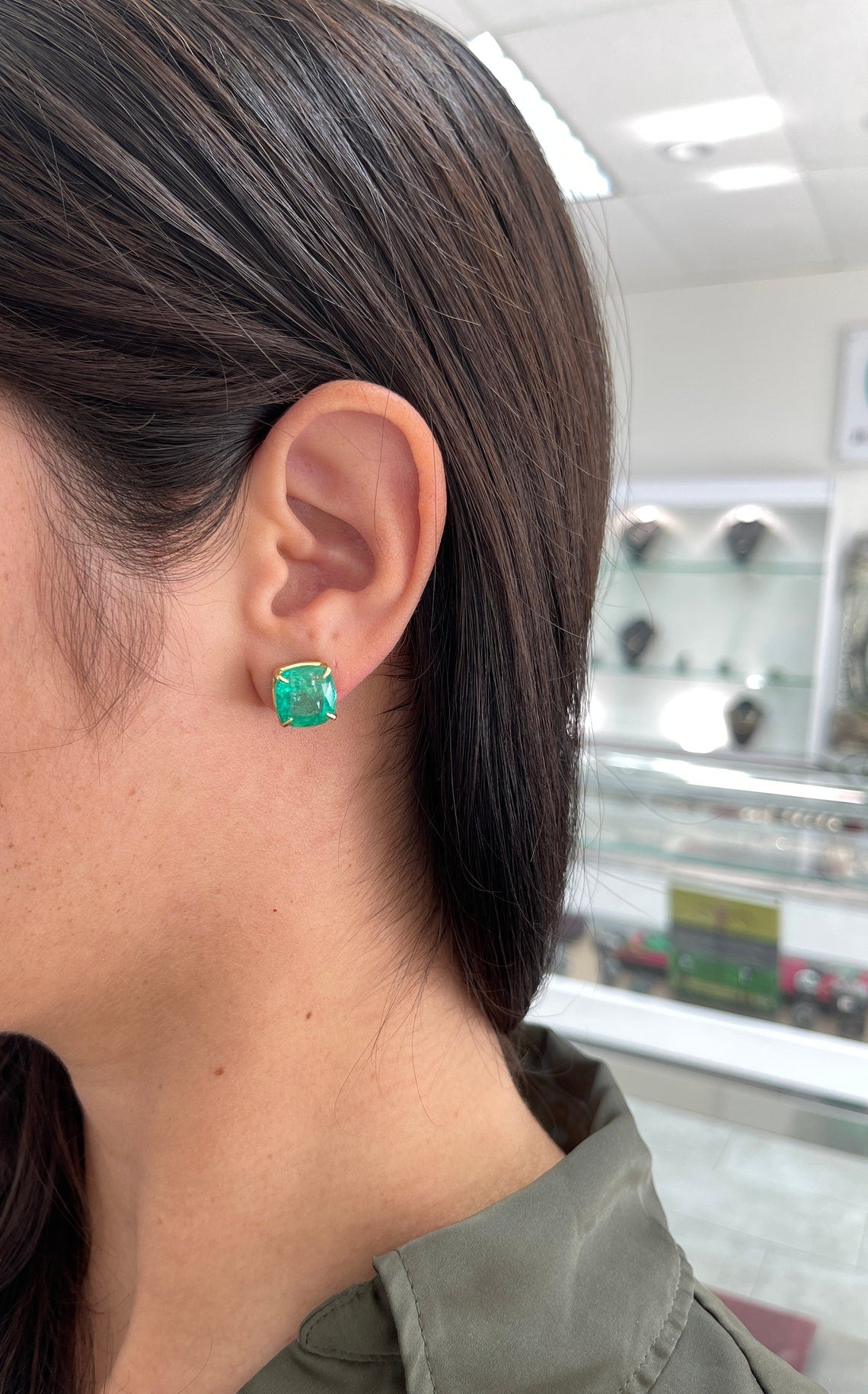 Colombian Emerald earrings with 11.80tcw AAA cushion cut emeralds in 18K gold, featuring four-claw prong settings.