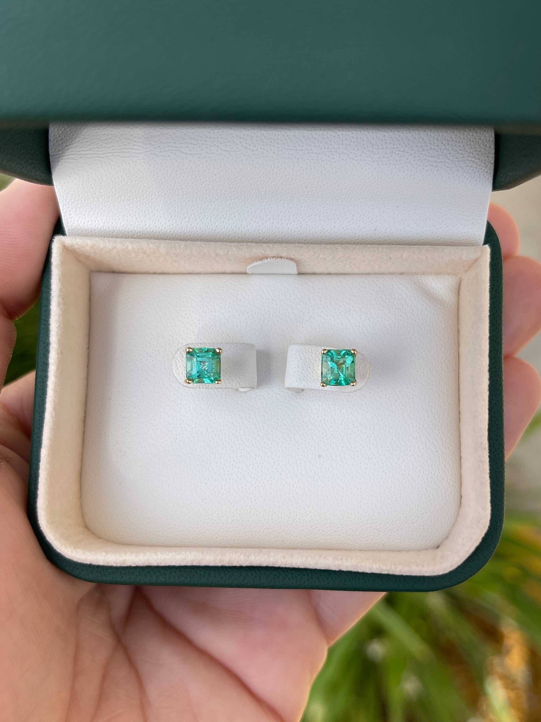 Colombian Emerald 2.05cttw Asscher cut screw back stud earrings in 14K gold, featuring vibrant green emerald gemstones.