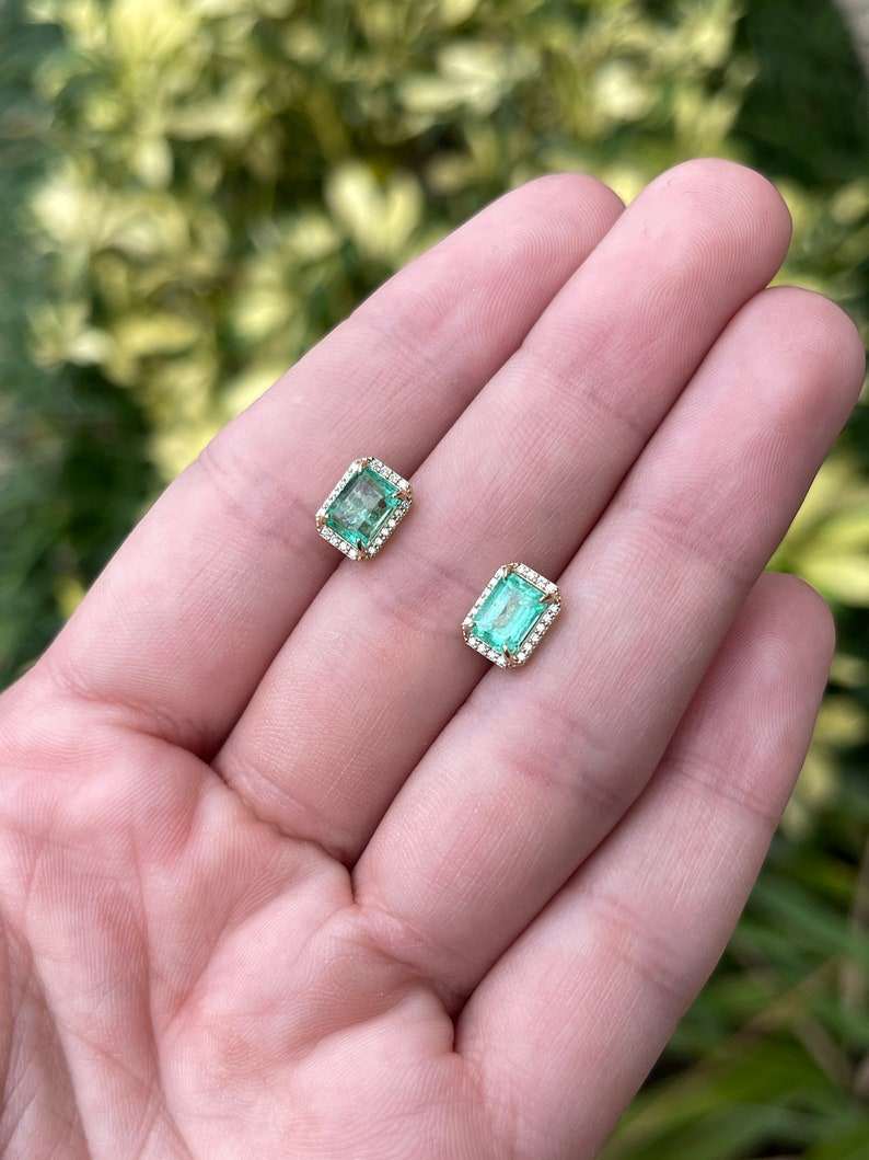 Colombian Emerald 14K gold stud earrings with 2.10tcw emerald-cut diamonds and halo setting, showcasing elegance and sparkle.