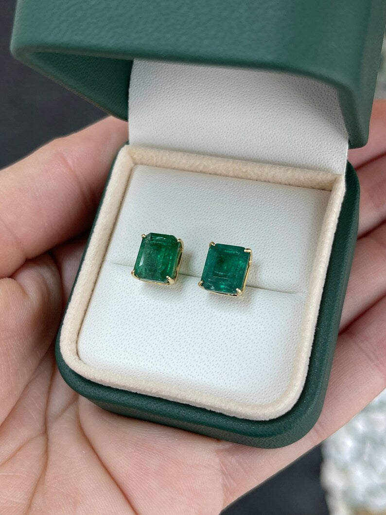 Colombian Emerald 18K gold stud earrings featuring large natural emeralds with four-prong settings and fine craftsmanship.