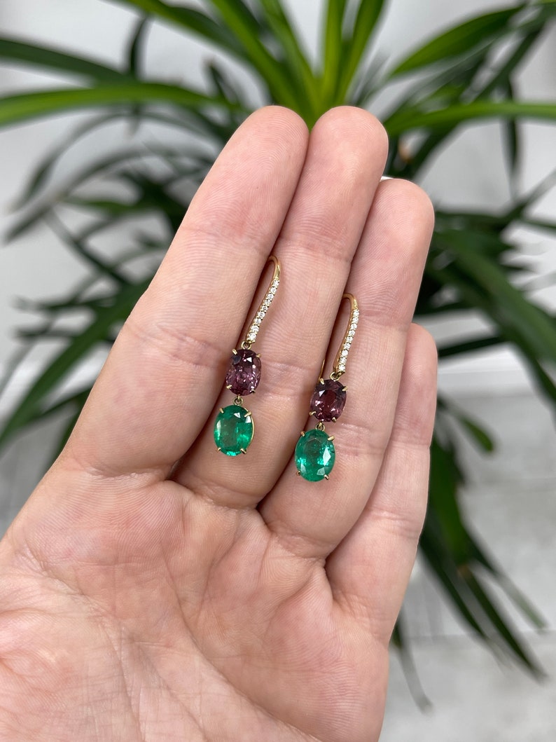 Colombian Emerald Luxurious 18K green emerald spinel and pave diamond dangle drop earrings showing intricate design and vibrant gemstones