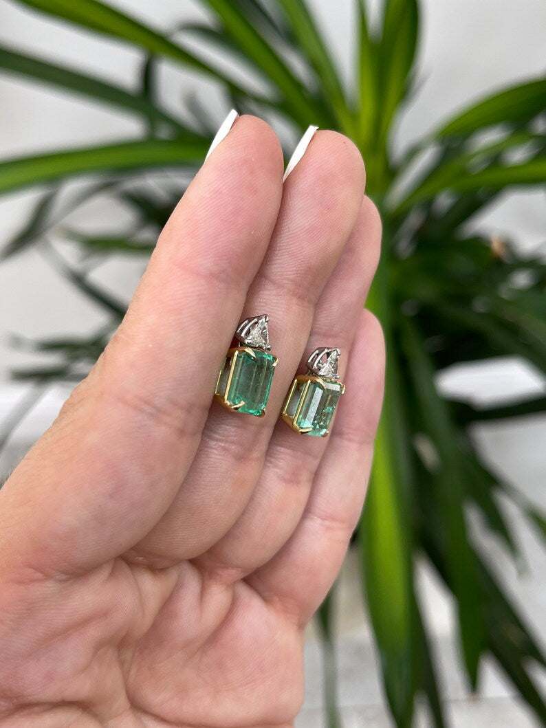 Colombian Emerald brand two-stone stud earrings with 6.73tcw platinum 18K gold, emerald cut emeralds and diamond trillion accents