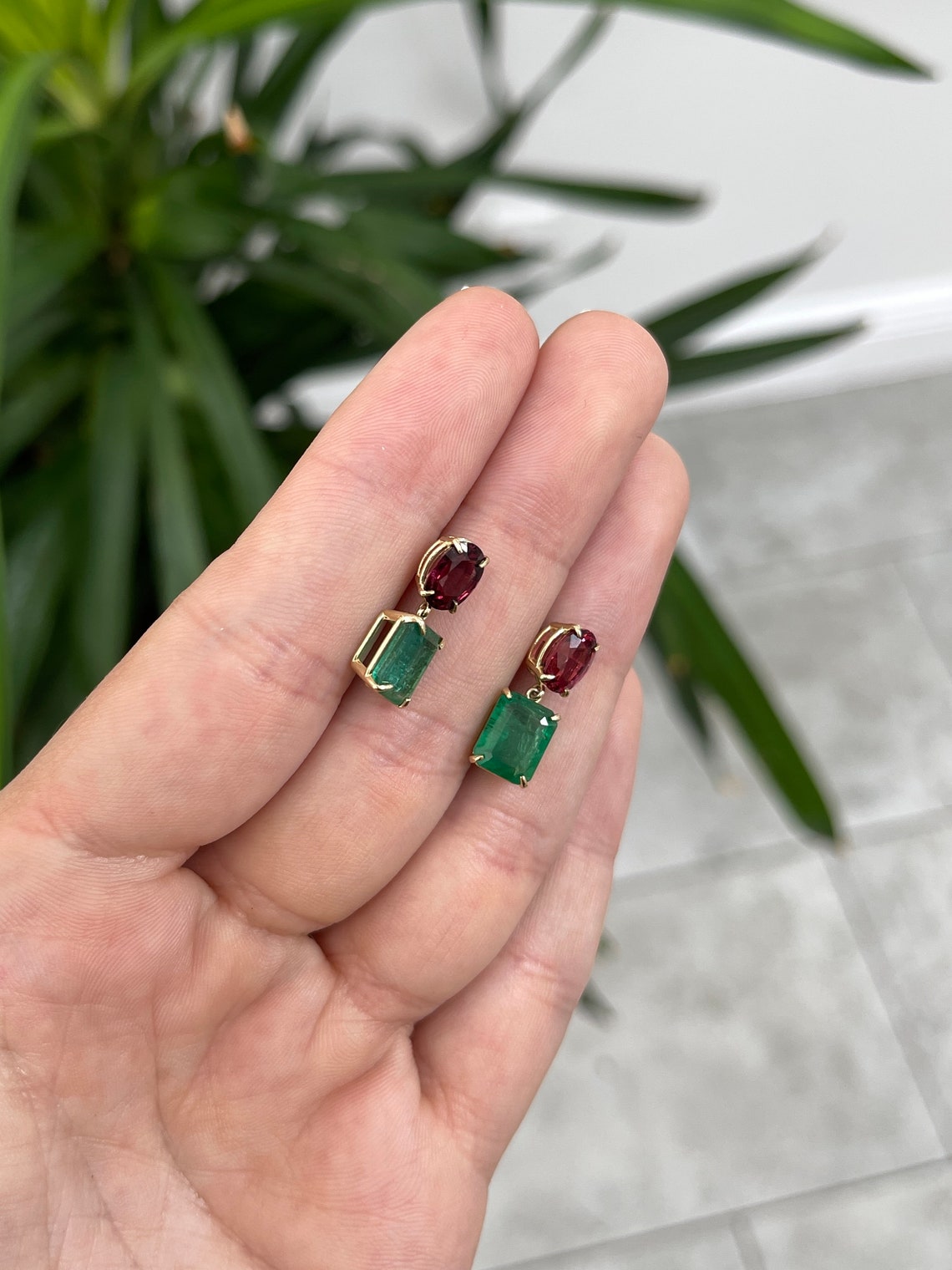 14K gold dangle earrings with natural emerald and oval-cut spinel, featuring a 7.09 carat total weight, from Colombian Emerald.