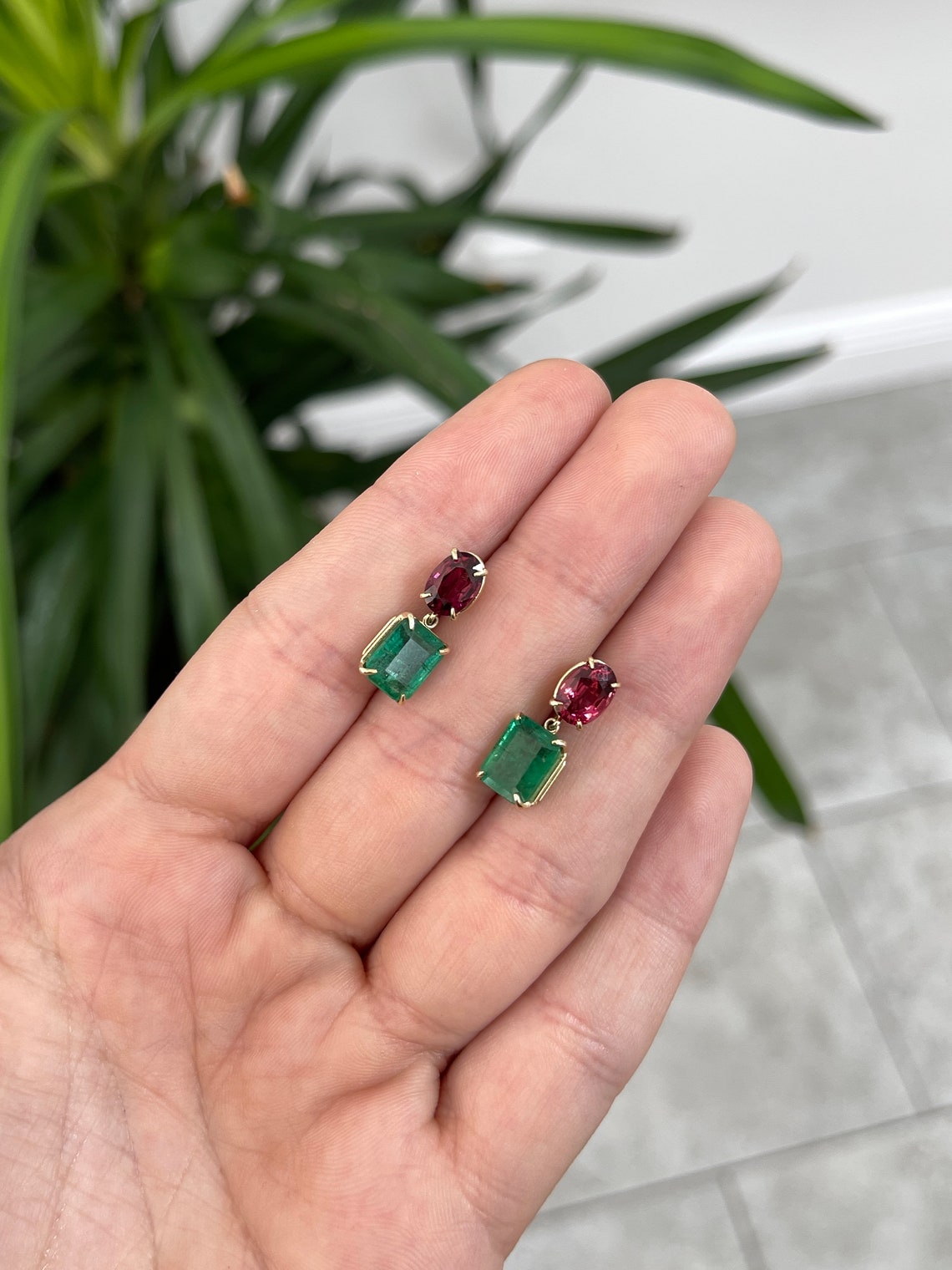 14K gold dangle earrings featuring natural emeralds and oval-cut spinel stones, showcasing elegant Colombian gemstone jewelry.