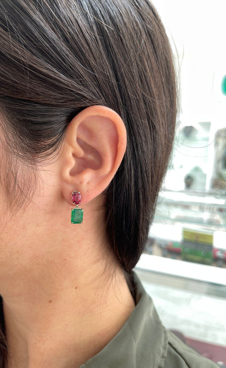 Gold dangle earrings featuring natural emerald and oval-cut spinel gemstones, crafted in 14K gold with a Colombian Emerald design.