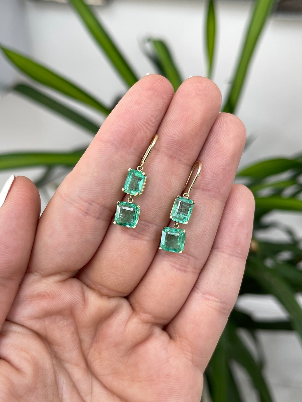Colombian Emerald 14K gold dangle earrings featuring natural emeralds and Asscher cut stones on hook wire for women.
