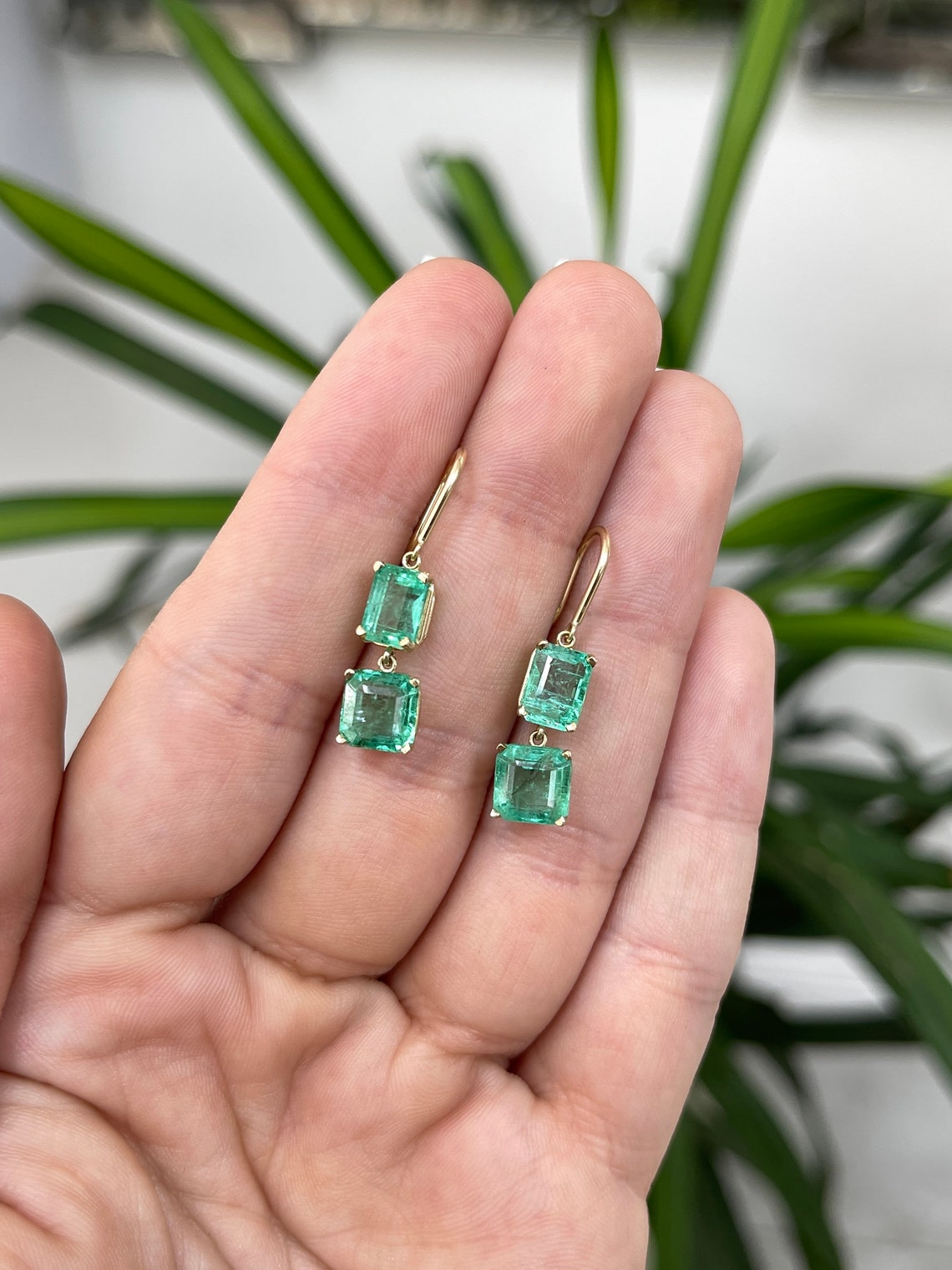 Colombian Emerald 14K gold dangle drop hook earrings with natural emerald and Asscher cut gemstones.
