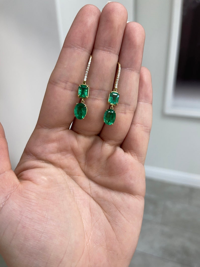 Colombian Emerald dark green diamond accents dangle earrings in 18K gold with 9.49tcw natural fine quality emeralds.
