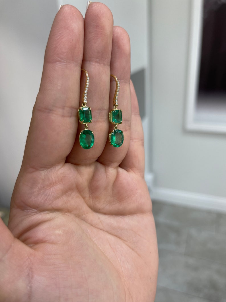 Dark emerald and diamond accent dangle earrings in 18K gold, featuring fine quality Colombian emeralds and elegant design.