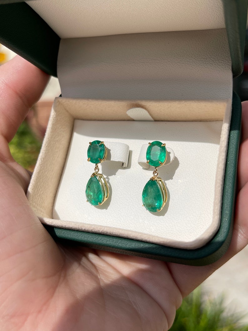 Colombian Emerald dangle earrings with dark green oval and pear-shaped emeralds, 9.78 carats, set in 18K gold.