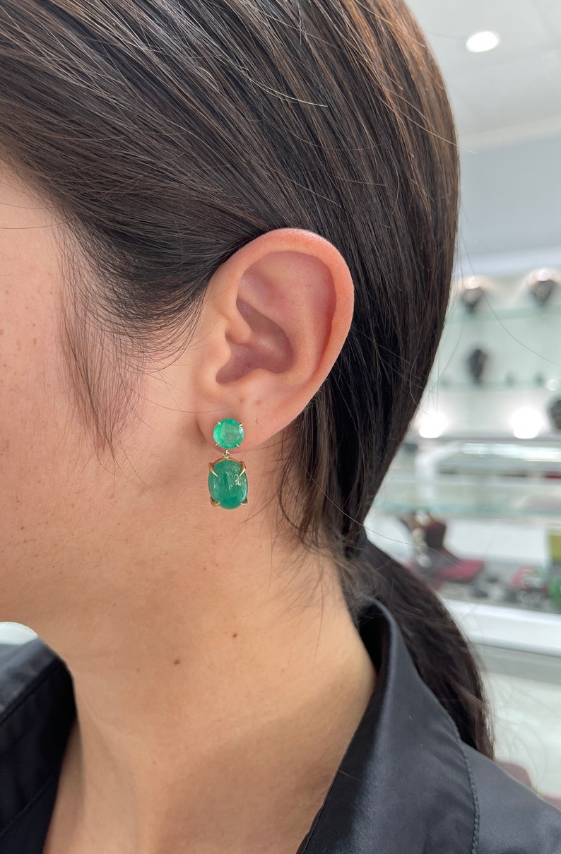 Colombian Emerald earrings with round and oval cut stones in yellow gold dangle style, totaling 16.82 carats.