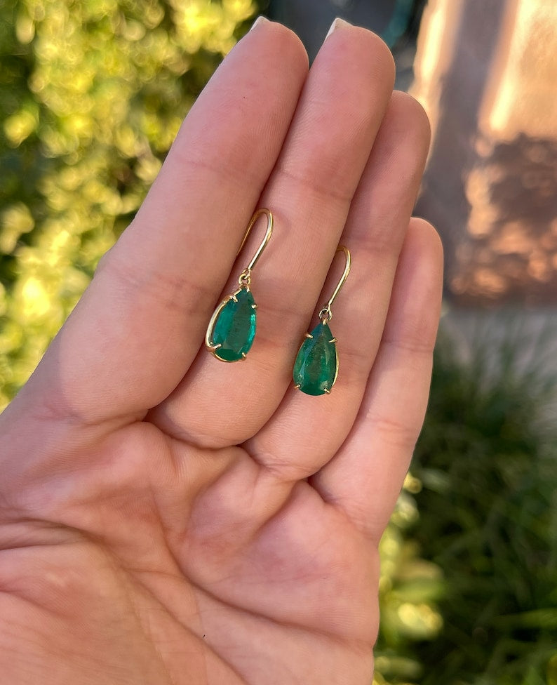 Colombian Emerald earrings with 5.0 carats of dark green teardrop-shaped emeralds on hook dangle earrings.