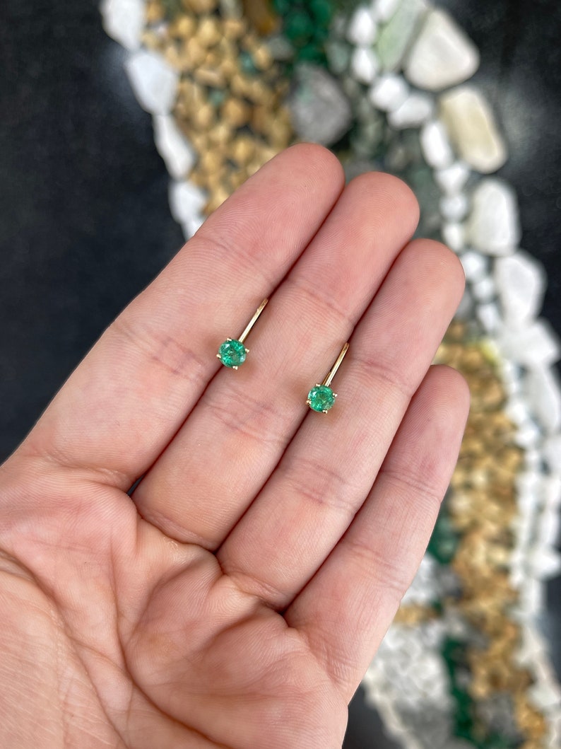 14K yellow gold round emerald leverback earrings with 0.80 carats total weight, featuring vibrant Colombian emeralds.