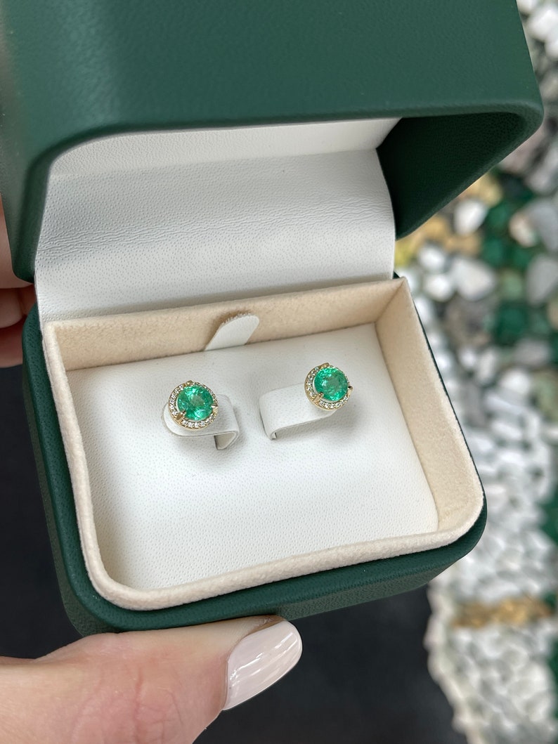 14K gold round emerald and diamond halo stud earrings with 2.32tcw, featuring vibrant green emeralds and sparkling diamonds.