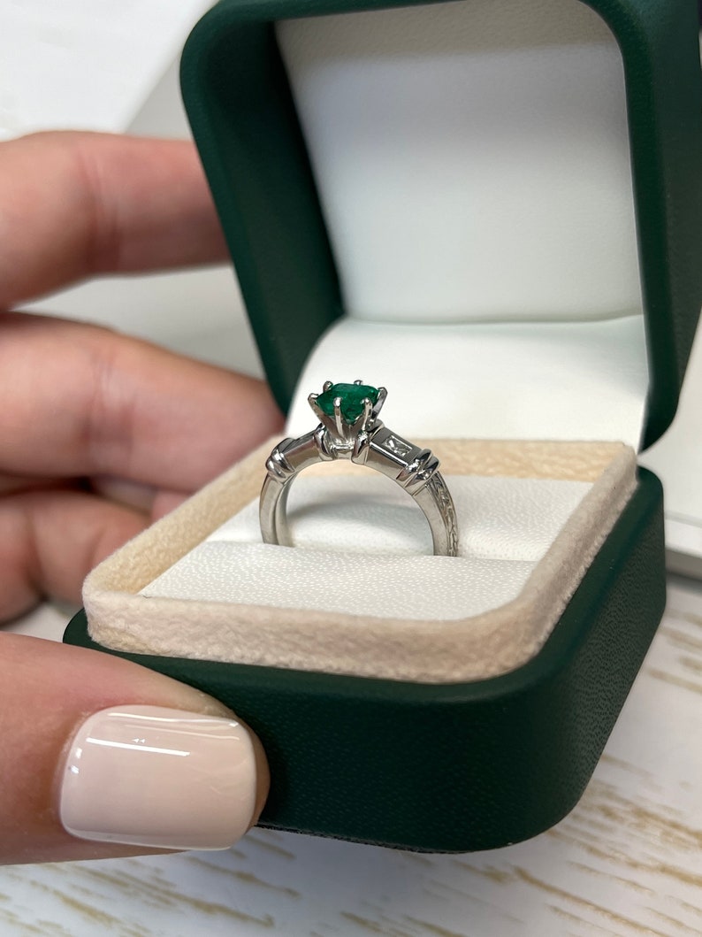 Emerald engagement ring featuring 1.20tcw Asscher emerald and princess cut diamonds in 18K gold, Colombian Emerald brand.