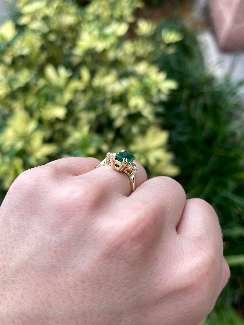 Colombian Emerald natural three stone engagement ring with 2.78tcw emerald cut and round diamonds in 18K setting, deep dark alpine green.
