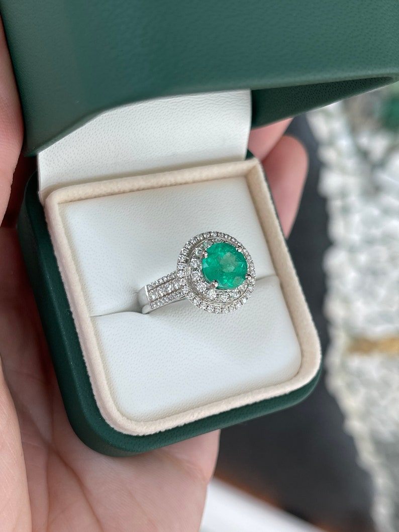 14K white gold emerald engagement ring with round emerald center stone and double diamond halo, Colombian Emerald brand.