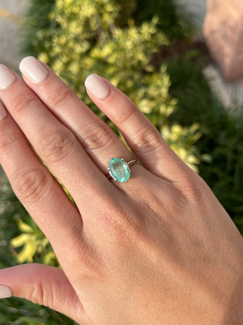 14K white gold emerald solitaire engagement ring with 3.55ct oval cut Colombian emerald and 6-prong setting.