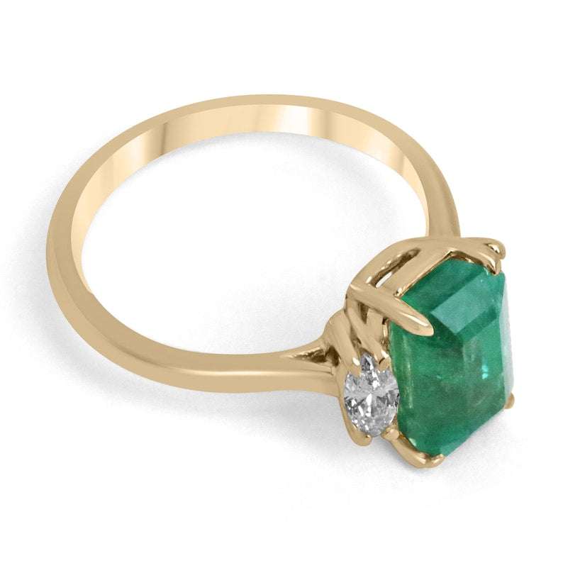 Medium bluish green emerald and marquise cut diamond three-stone engagement ring in 14K gold, featuring Colombian emerald.