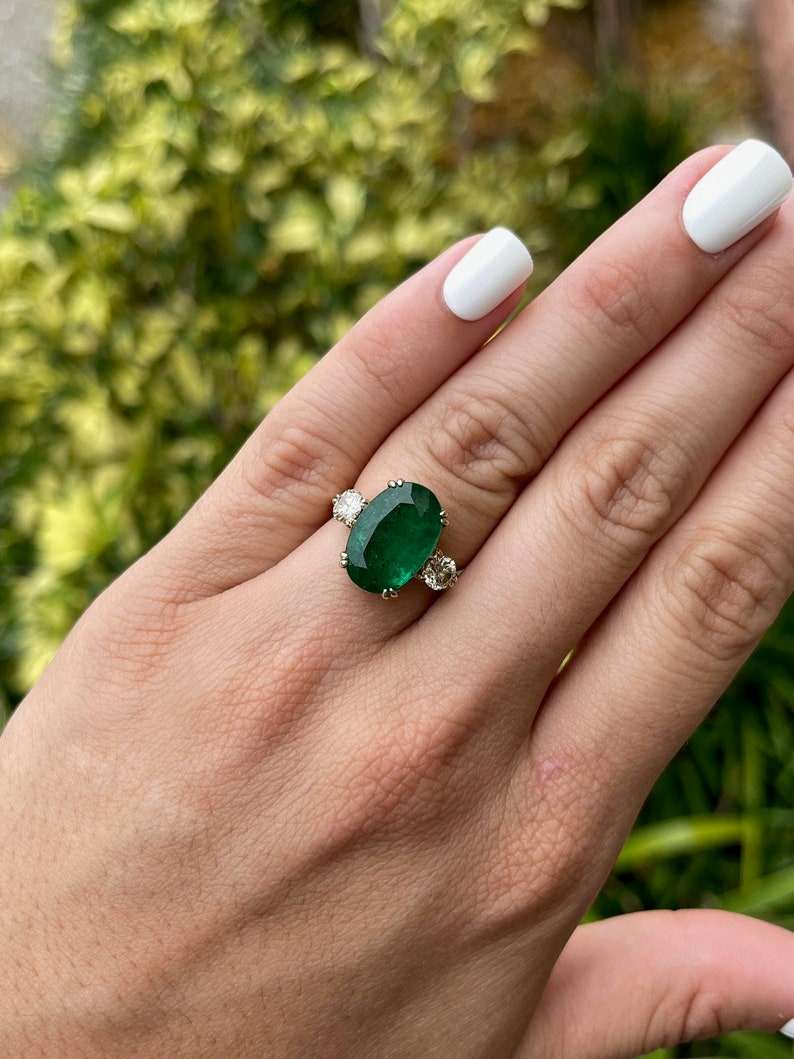Dark green oval emerald and round diamond 3-stone engagement ring in 14K with double prong setting, by Colombian Emerald.