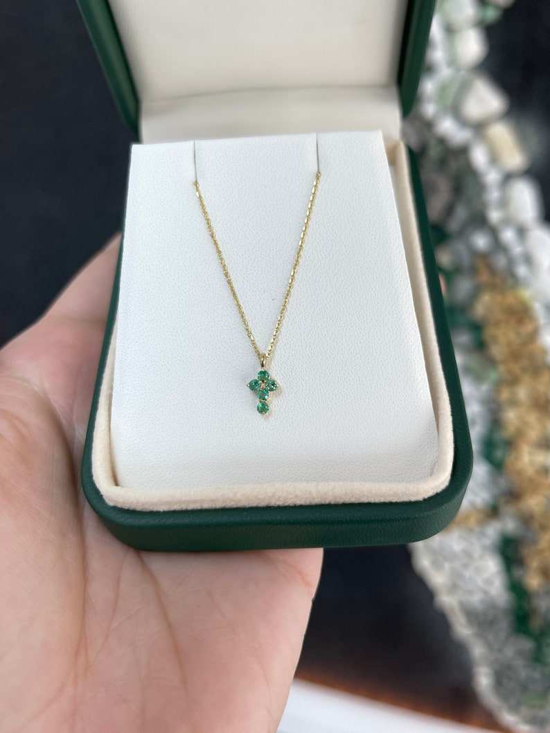 14K yellow gold child's baptism cross necklace with a petite round Colombian emerald, 0.15 tcw, featuring a religious pendant.