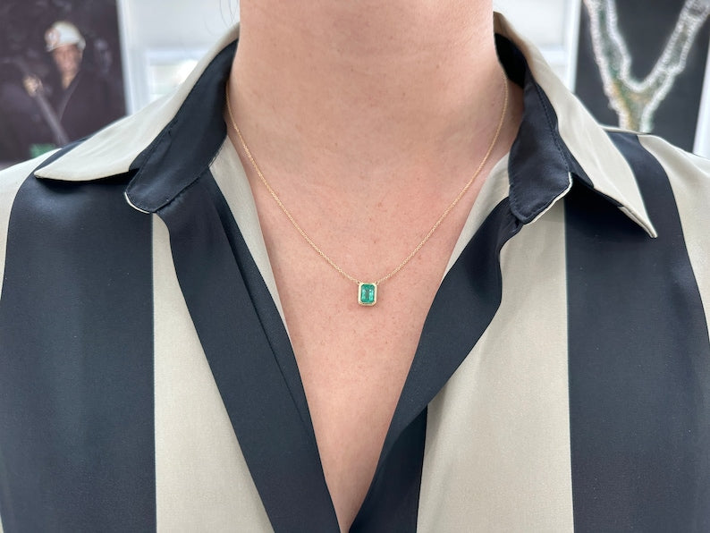 Colombian emerald cut bezel set green emerald necklace on a gold adjustable chain, featuring a 1.90ct medium lush green gemstone.